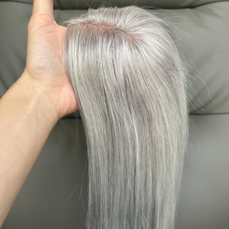 Lightweight silver grey hair topper shown in hand