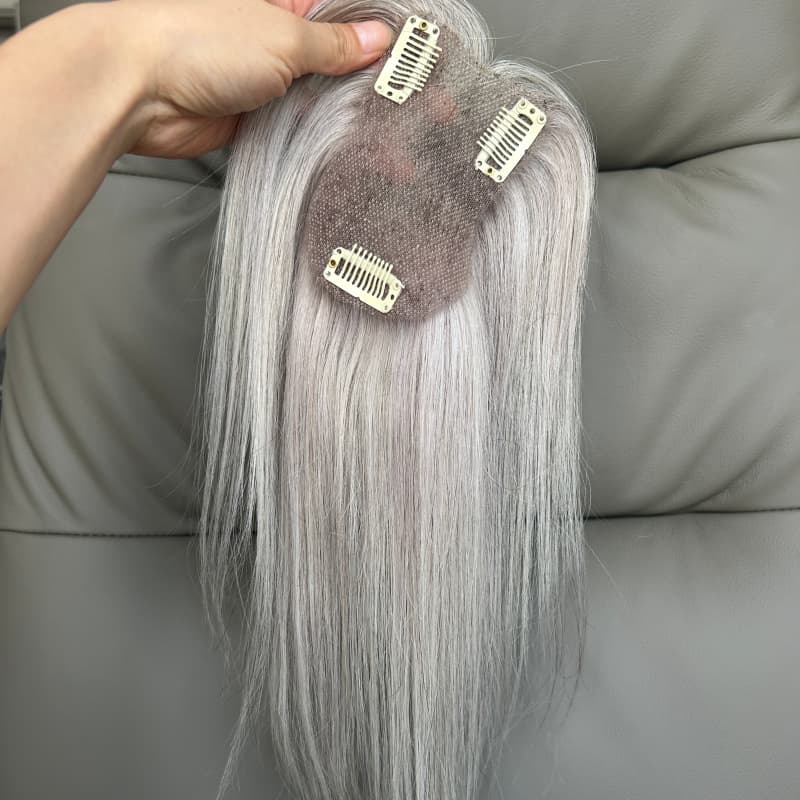 Underside of silver grey lace topper with three clips