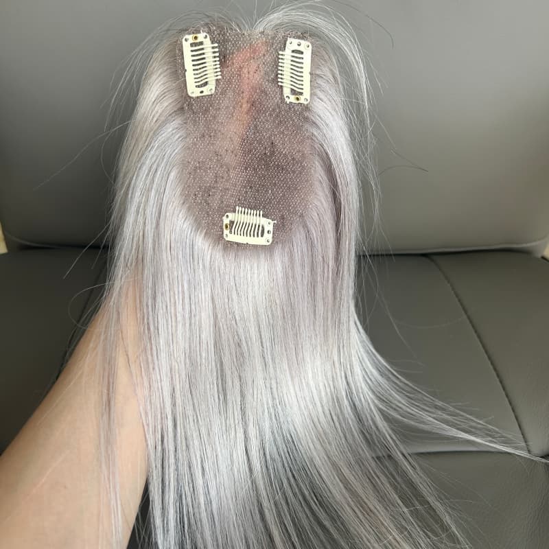 Close-up of lace base and clips on grey hair topper