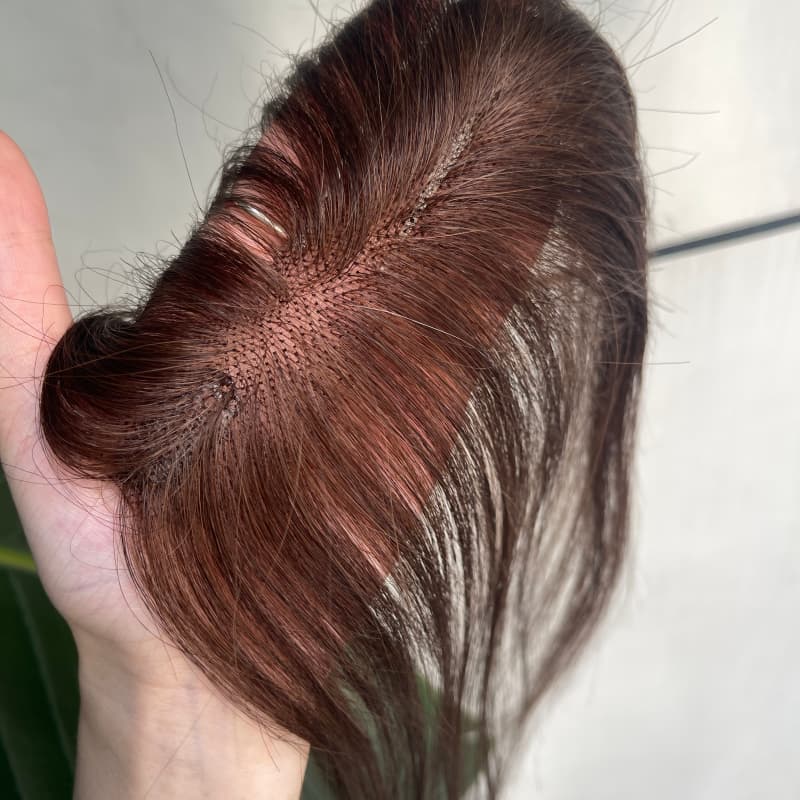 Close-up of natural parting on brown lace hair topper