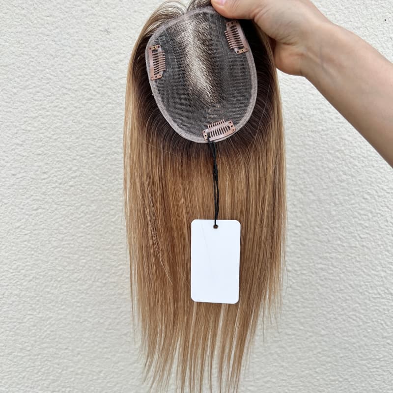 Underside of brown gradient topper with three clips