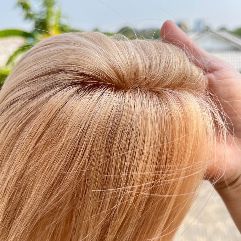 Milk tea blonde human hair topper close-up at the crown