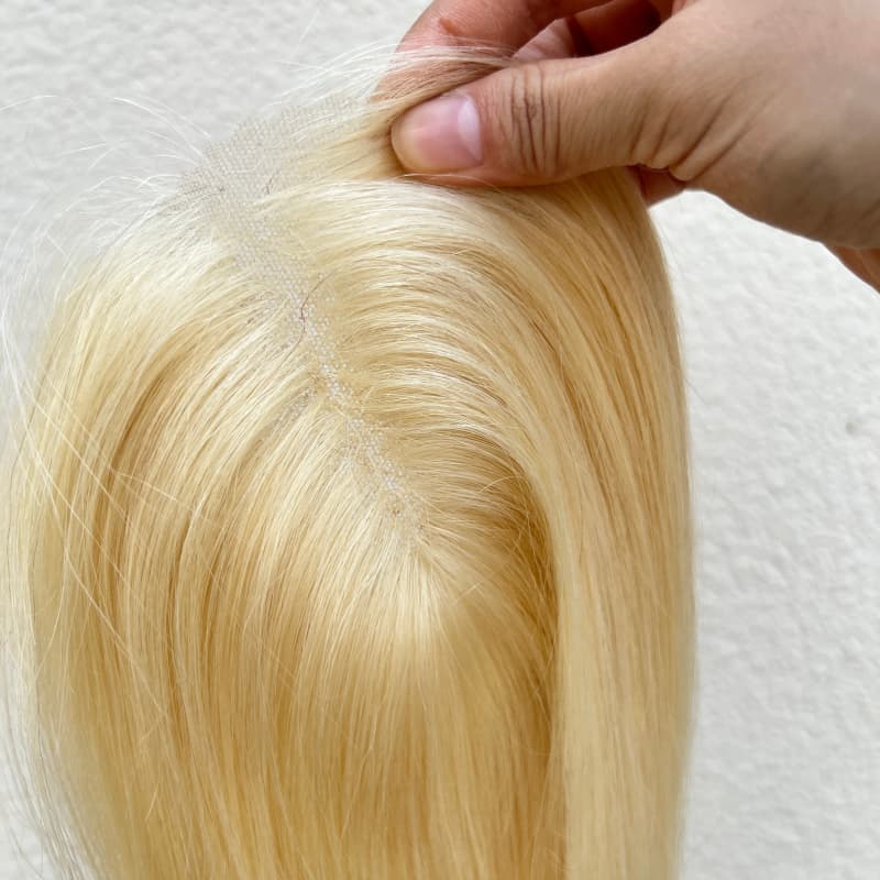 Close-up of natural parting on blonde human hair topper