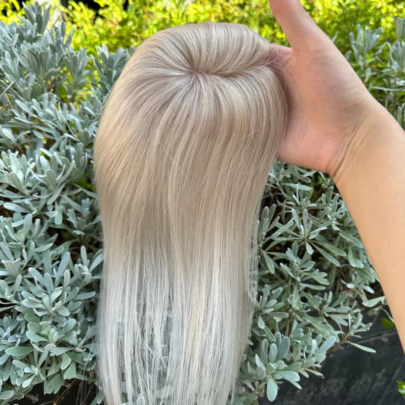 Platinum blonde human hair topper with a realistic-looking part