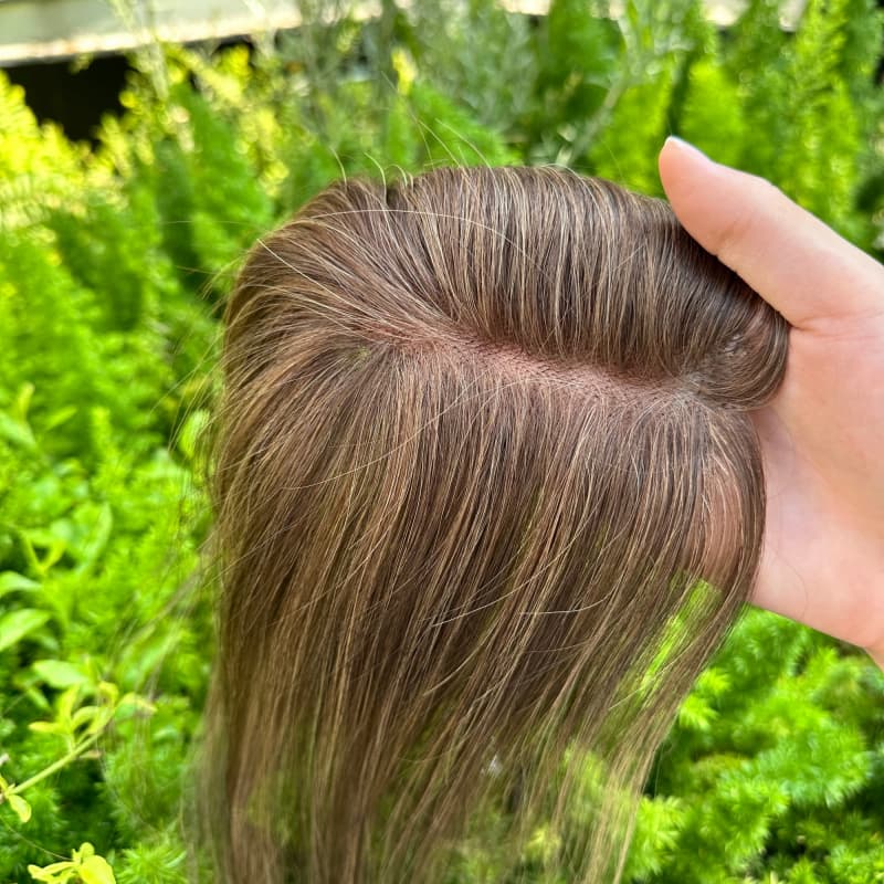 Brown highlighted hair topper close-up showing color dimension