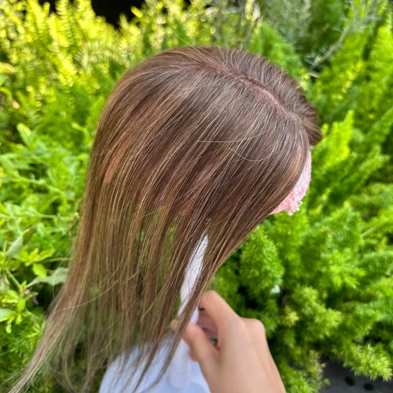 Brown hair topper with soft highlights, top view