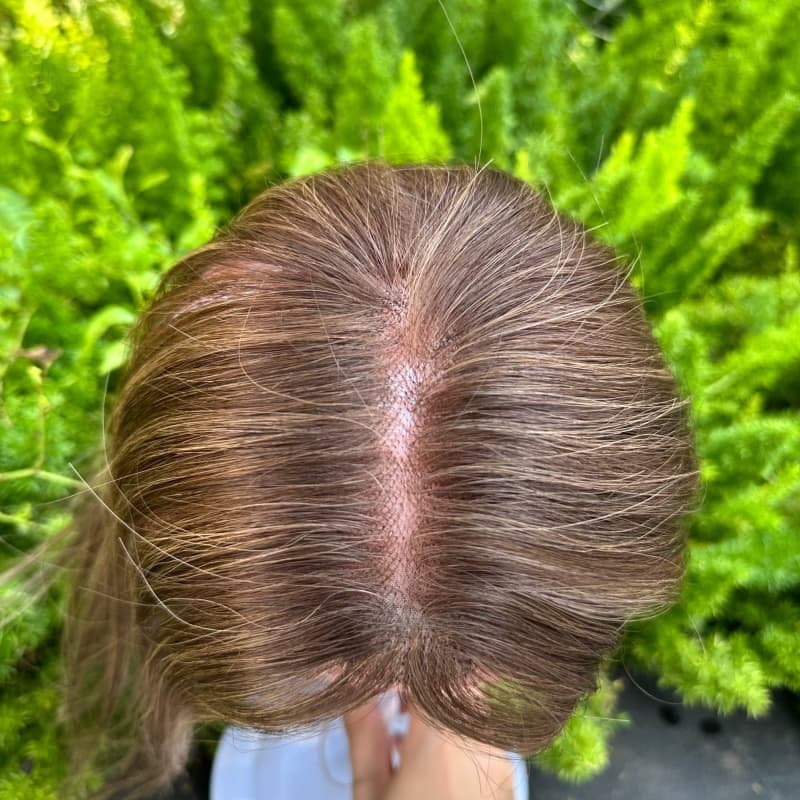 Brown highlighted human hair topper showing crown coverage