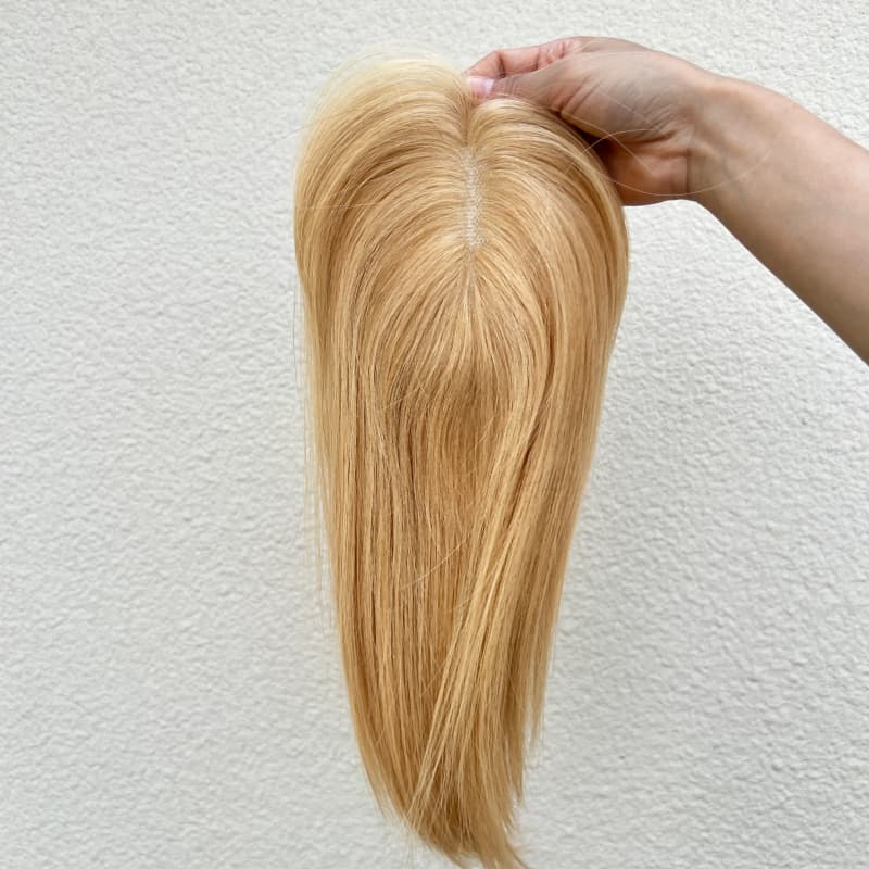 Close-up of natural parting on Color #27 hair topper