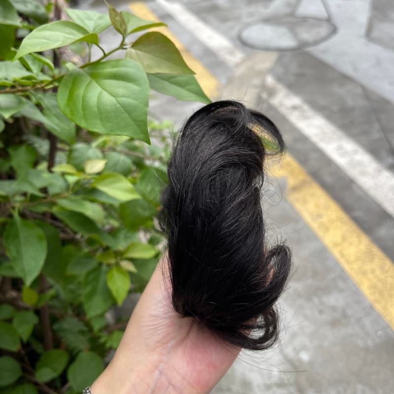 100% human hair bun scrunchie, color 1B#, outdoor natural-light photo 2