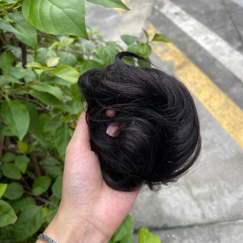 100% human hair bun scrunchie, color 1B#, outdoor natural-light photo 3