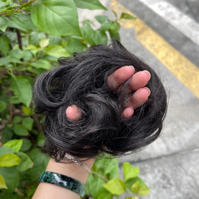 100% human hair bun scrunchie, color 1B#, outdoor natural-light photo 5
