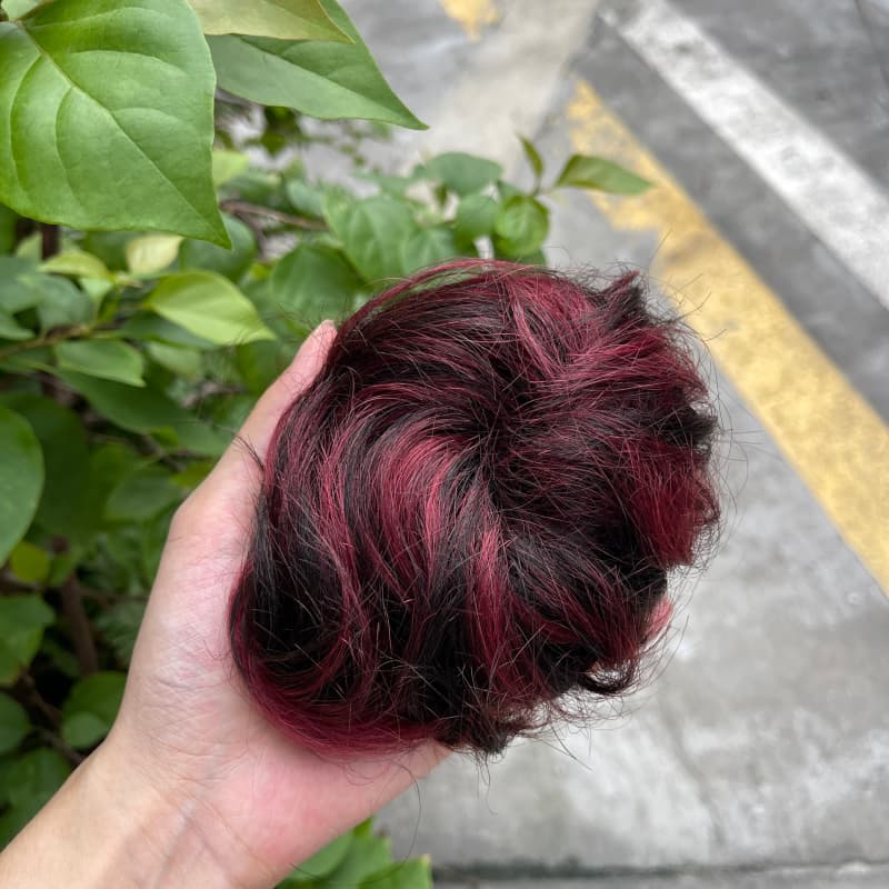 100% human hair bun scrunchie, color 1B99J, outdoor natural-light photo 1