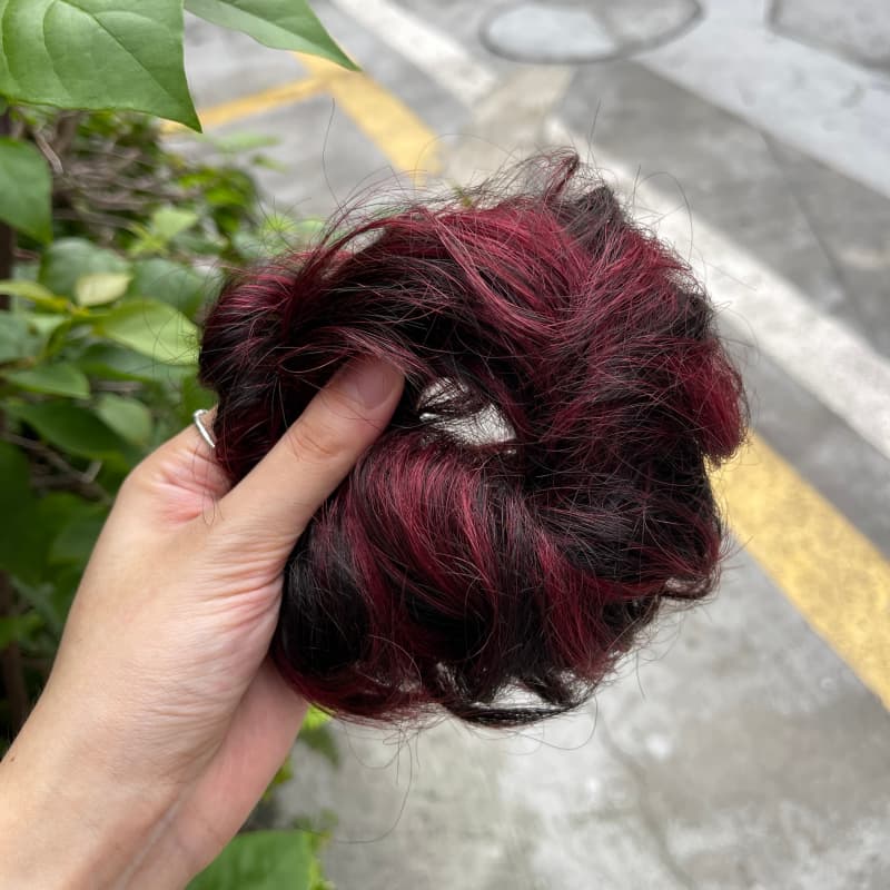 100% human hair bun scrunchie, color 1B99J, outdoor natural-light photo 4