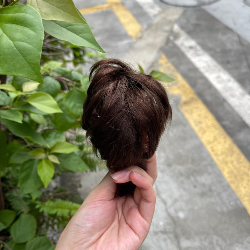100% human hair bun scrunchie, color 2#, outdoor natural-light photo 2