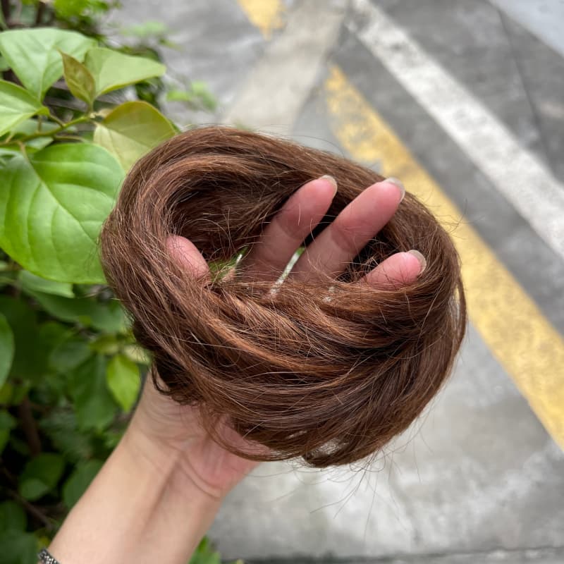 100% human hair bun scrunchie, color 4-6, outdoor natural-light photo 5
