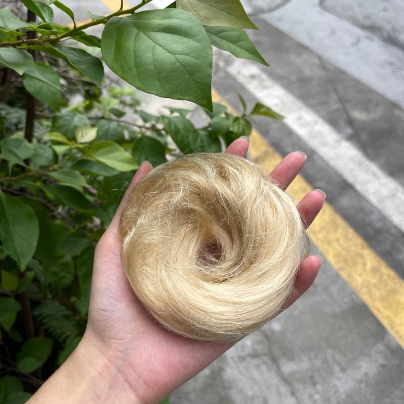 100% human hair bun scrunchie, color 613#, outdoor natural-light photo 1