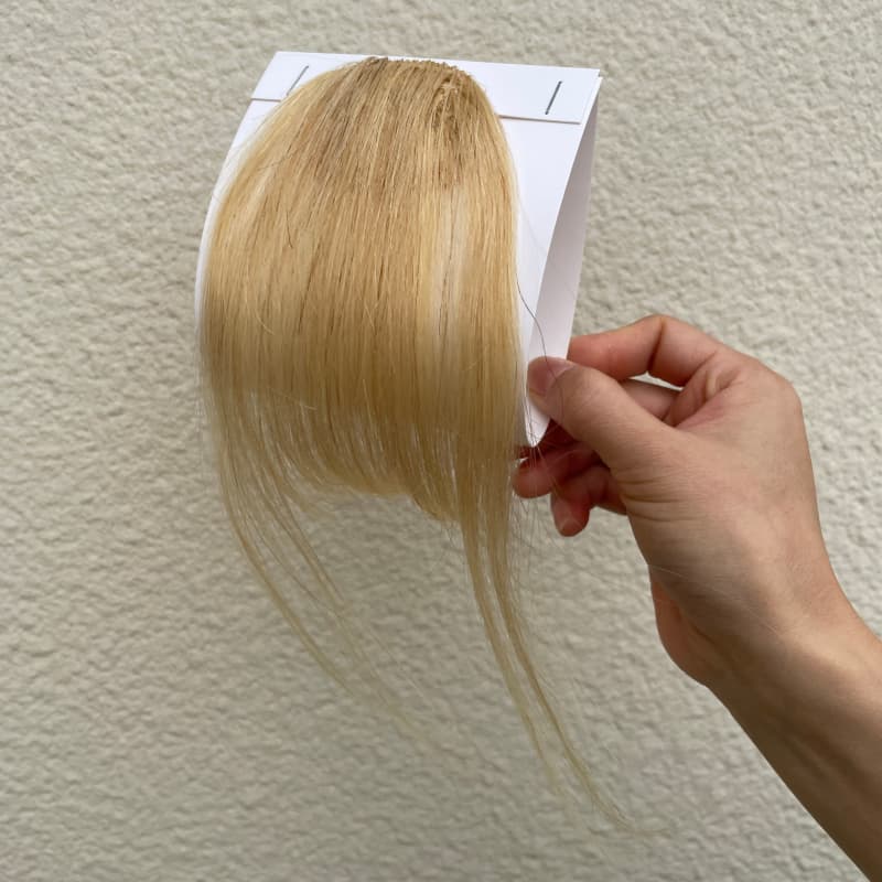 #613 blonde human hair clip-in bangs with longer face-framing sides