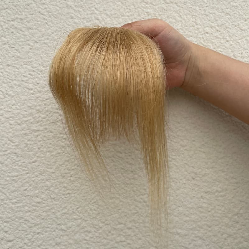 Ash blonde human hair clip-in bangs with face-framing side strands