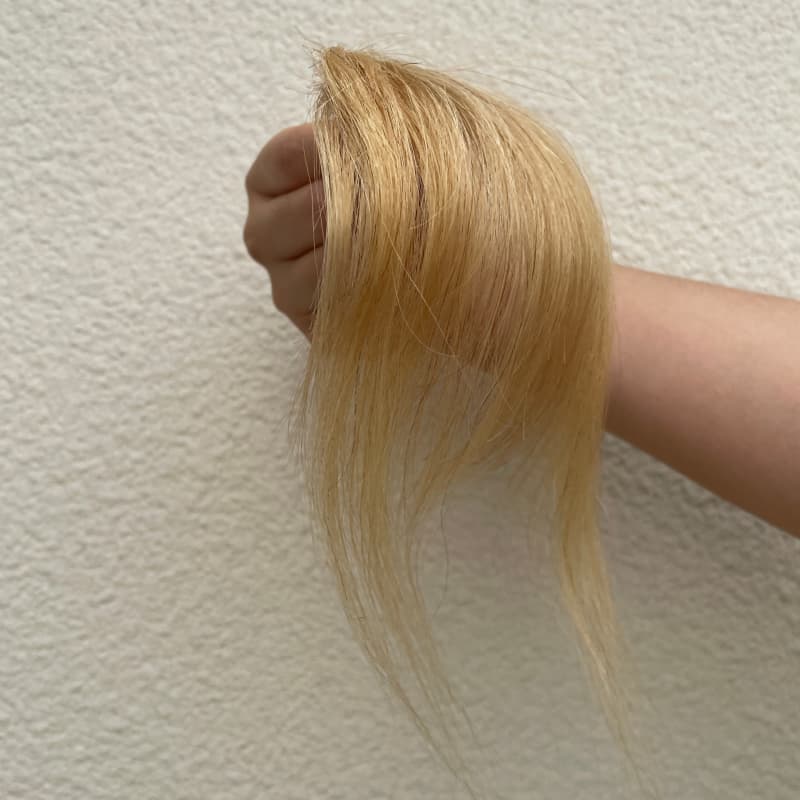 Ash blonde human hair clip-in bangs with face-framing side strands