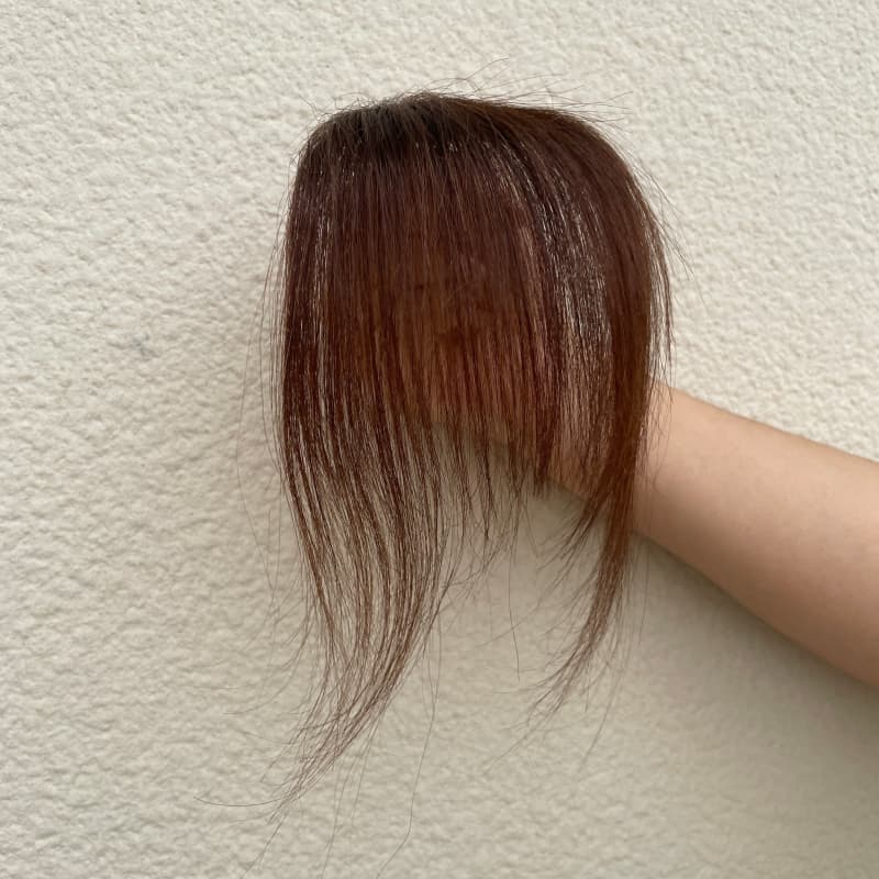 Dark brown human hair clip-in bangs with face-framing side strands