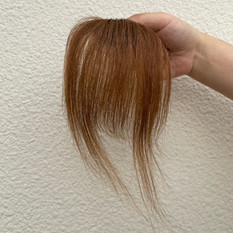 Medium brown human hair clip-in bangs with longer face-framing sides