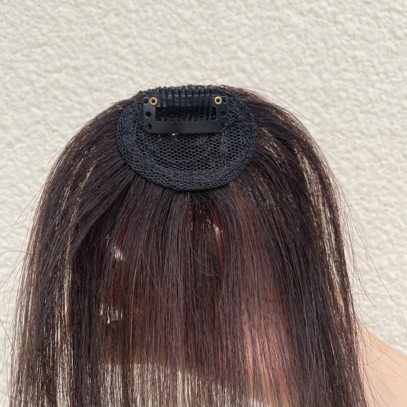 Natural black fringe hairpiece compact mesh base and single clip detail