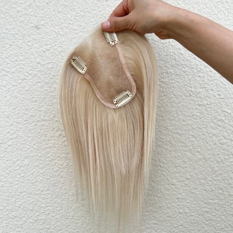 Close-up of natural parting on ivory human hair topper