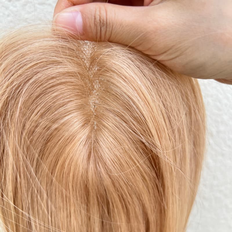 Lace base and clip attachment detail on milk tea blonde topper