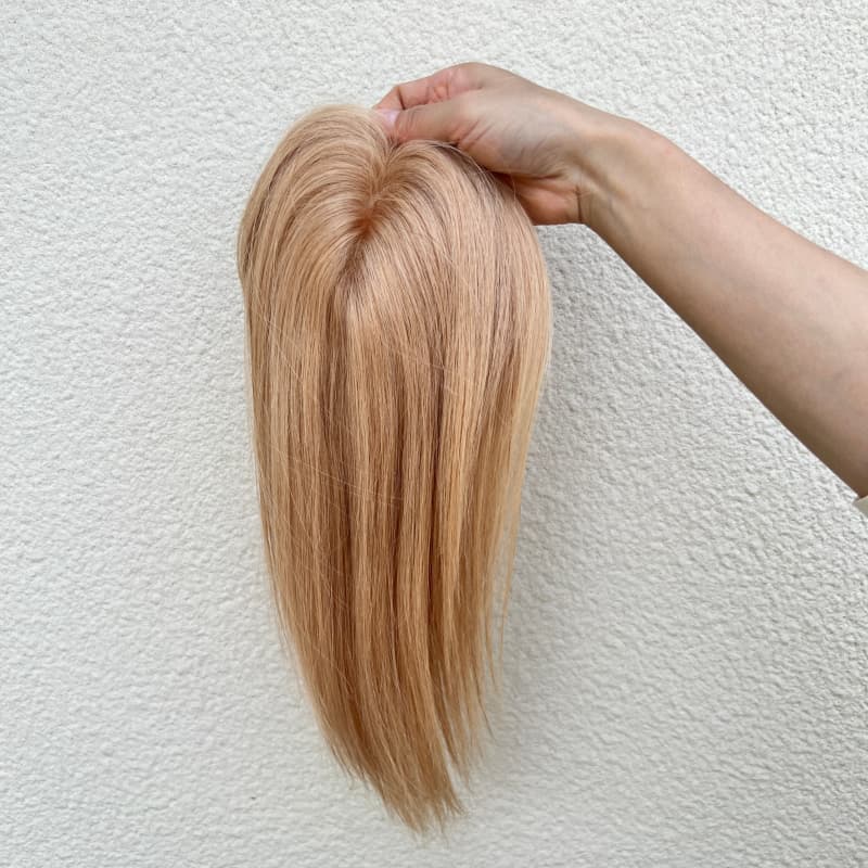 Milk tea blonde human hair topper close-up showing natural-looking part