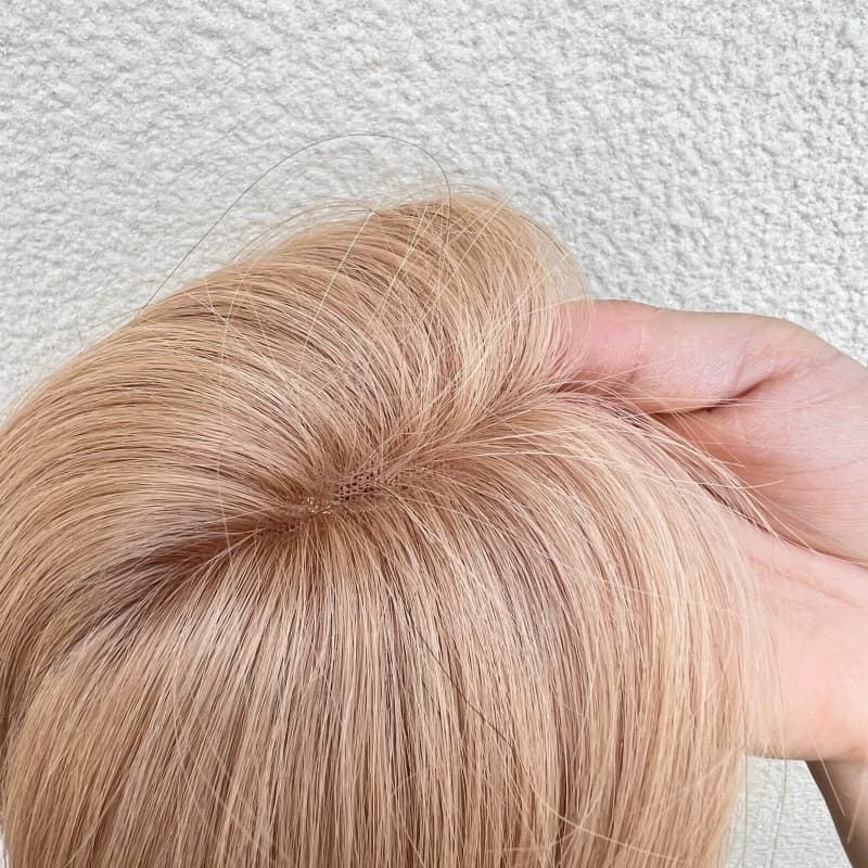 Underside of milk tea blonde topper showing its U-shaped lace base and clips
